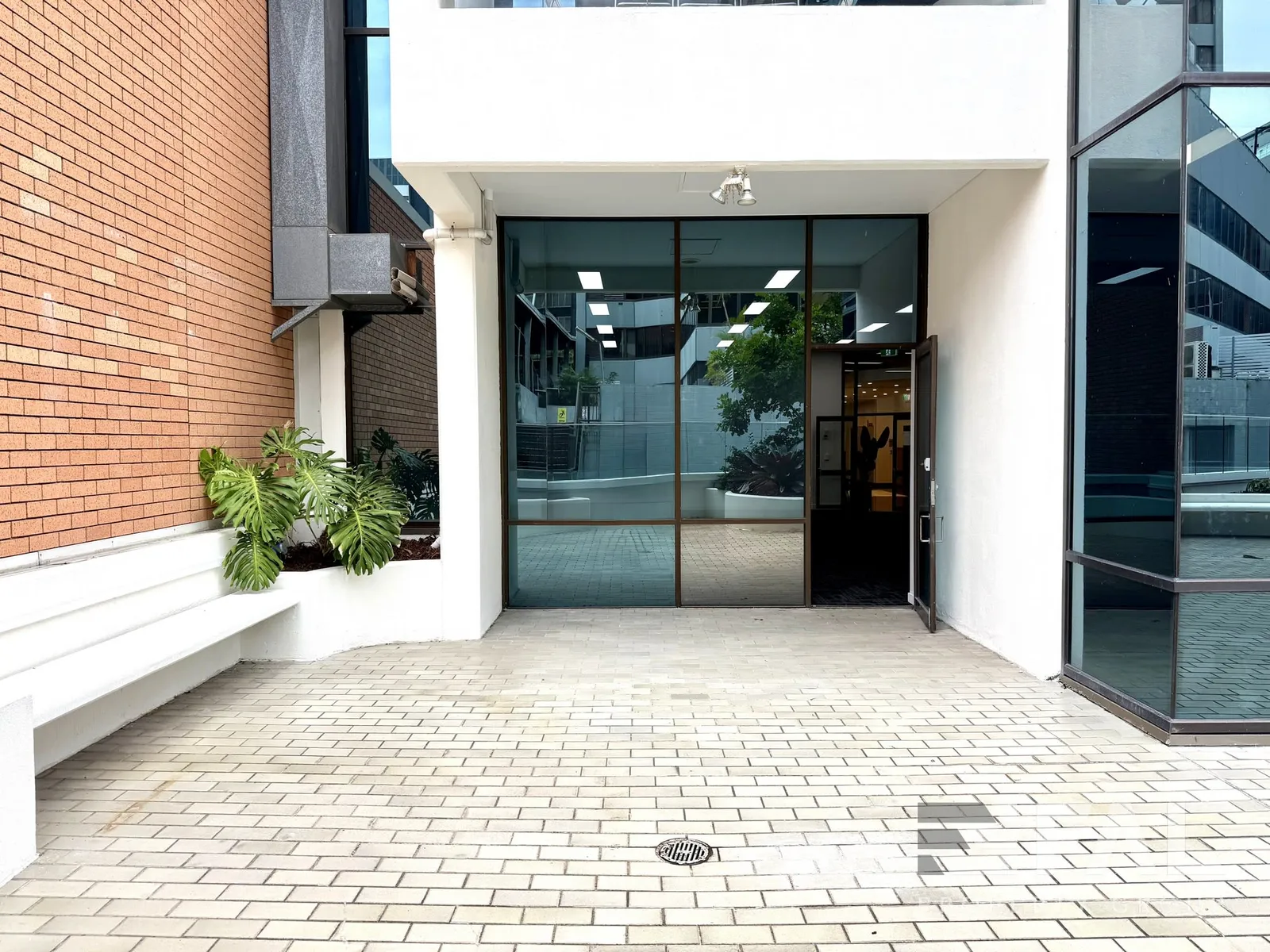 Glazed ground-floor tenancy frontage viewed from the adjoining courtyard