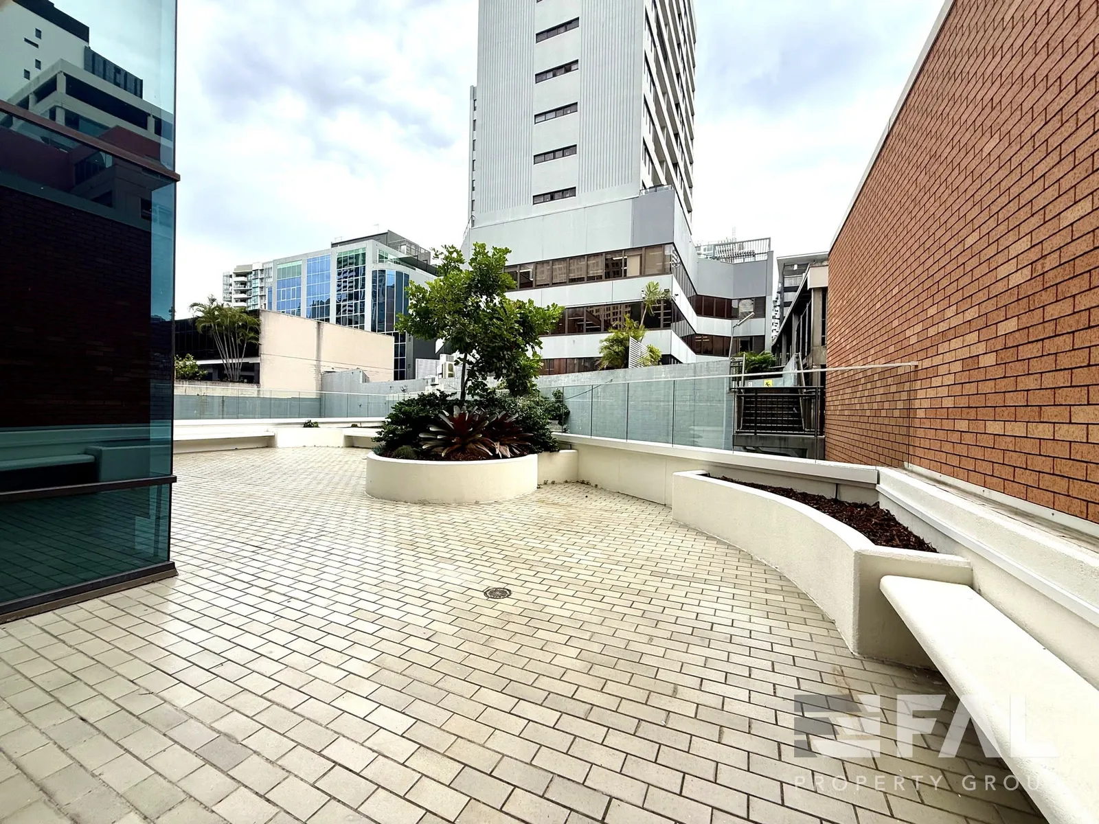 Wide view across the landscaped courtyard adjoining the ground-floor tenancy